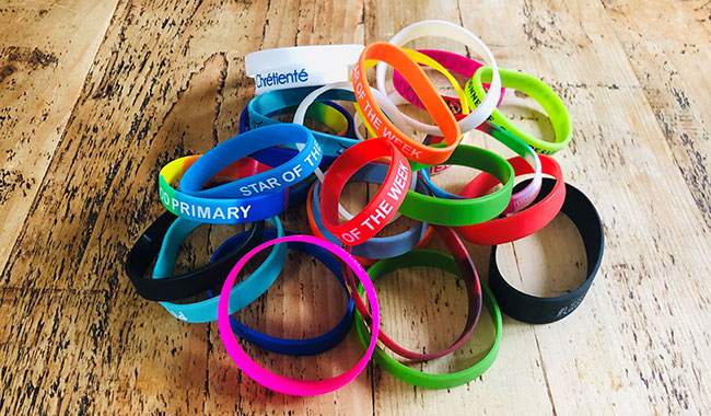 A variety of brightyly coloured personalised wrist bands